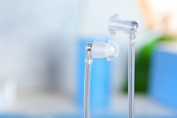 Hearing aids on blurred background, closeup