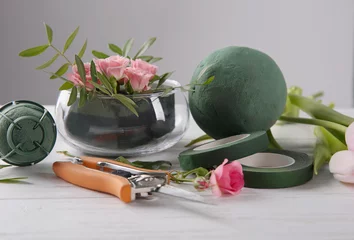 Foto auf Acrylglas Blumenladen Florist equipment with flowers on wooden table