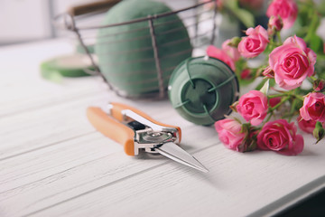 Florist equipment with flowers on table