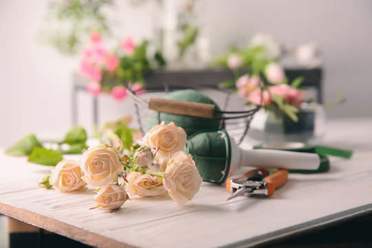 Florist equipment with flowers on table