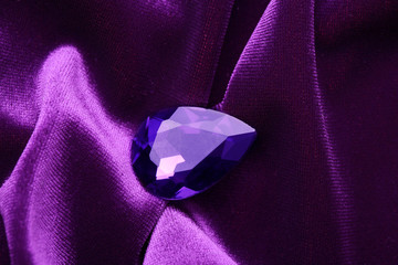 Precious stone for jewellery on purple velvet