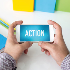 Man holding smartphone which displaying Action