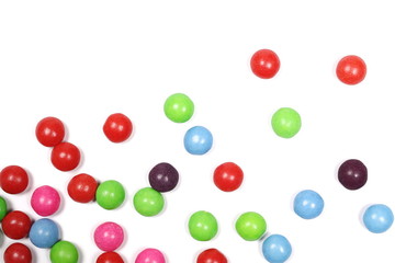 Colorful candies isolated on white background, top view