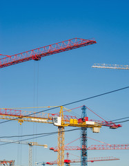 Many construction cranes on blue sky backgrounds. Construction Background