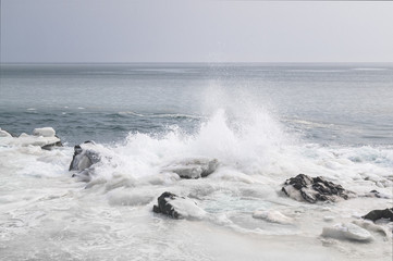 Sea shore in ice and waves. Far East sea landscape of Russia