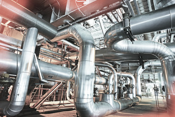 Equipment, cables and piping as found inside of a modern industrial power plant