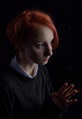 Fototapeta premium a girl is sitting and sad outside the window in rainy weather