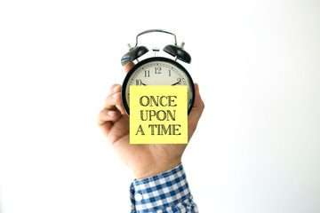 Hand Holding Alarm Clock and Pointing ONCE UPON A TIME