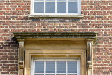 Squared Pediment above Window in Brick Wall, Shallow Depth of Field Architecture Details