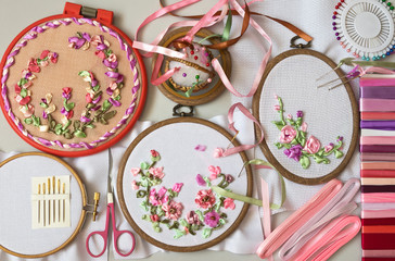 Needlework. Embroidery with satin ribbons of floral compositions in a pink gamma