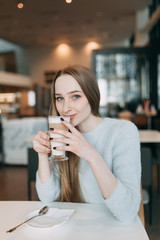 Pensive young woman in eyewear planning project sitting with laptop computer on cafe terrace near copy space for advertising, positive female student thinking about learning and coursework creation