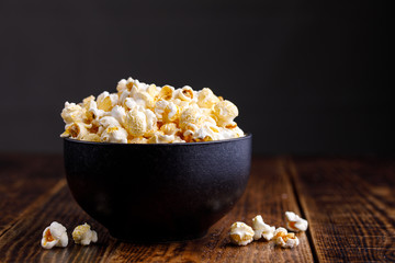 A dark, elegant ceramic bowl with seductive popcorn.