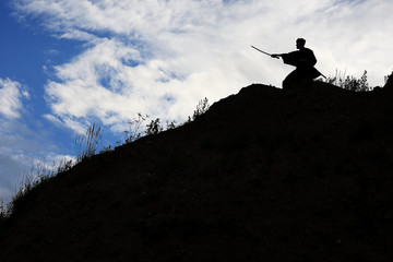 Fighter with a sword silhouette a sky ninja