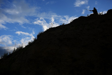 Silhouette black and white photo warrior with sword on the mountain