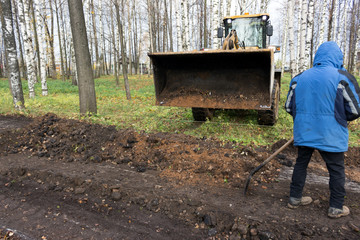 a bulldozer levels the ground at the site