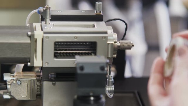 Hand Puts Tube with Raw Oil into Examination Case