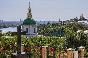 Fototapeta na wymiar Kiev Pechersk Lavra monastery, Cross, Ukraine. Church and river Dniepr panoramic view