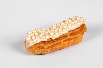 French dessert Eclair with white glaze on white background
