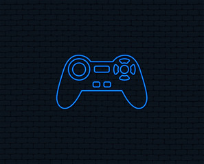 Neon light. Joystick sign icon. Video game symbol. Glowing graphic design. Brick wall. Vector