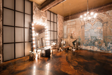 Loft interior with mirror, candles, brick wall, large window, living room in modern design