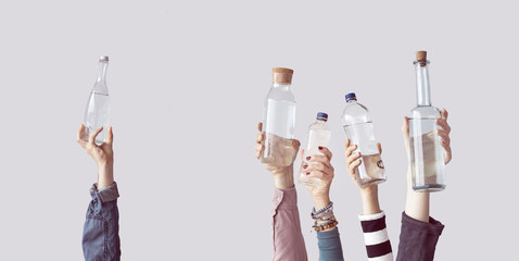 Different people holding water bottles