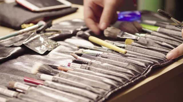 Make-up artist folding brushes in their places