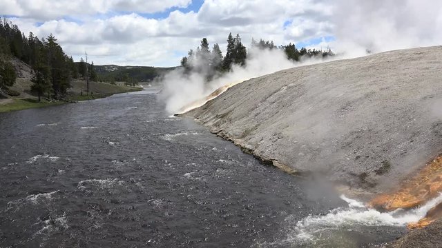 Water streams from the Midway Geyser Basin to Firehole River. Yellowstone NP, Wyoming, USA