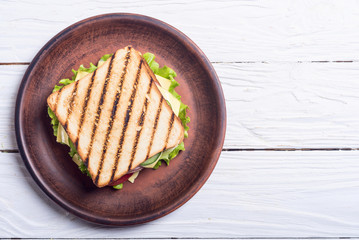 Club sandwich with tomatoes , cucumber , ham and cheese