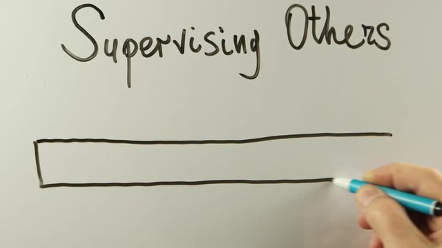 Male hand writes on the whiteboard words related with leadership skills