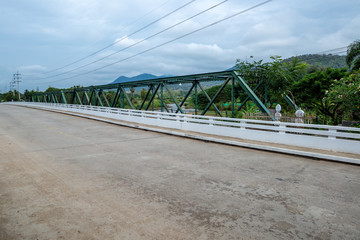 Metal Truss beam bridge with concrete road in countryside hill, Traveling in Thailand