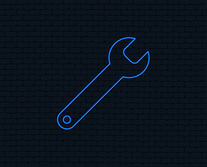 Neon light. Wrench key sign icon. Service tool symbol. Glowing graphic design. Brick wall. Vector