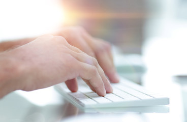 close-up of hand typing text on computer keyboard.