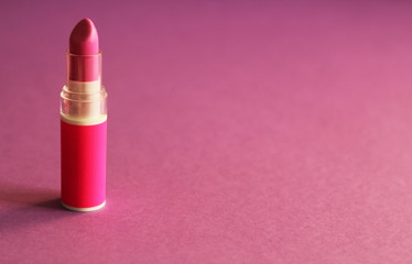 Pink lipstick close up, powder pink background, free copy space