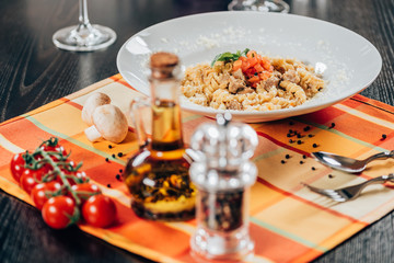 gourmet pasta with roasted pork and olive oil on table