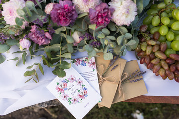 Wedding invitations in the craft envelopes with a bunches of lavender. Wedding concept. Wedding accessories. 