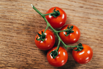 top view of fresh ripe cherry tomatoes on wooden table