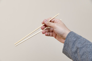 Hand Holding Chopsticks