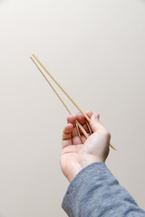 Hand Holding Chopsticks