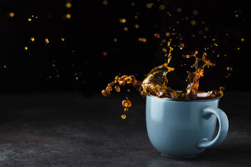 Cold coffee splash in a blue cup