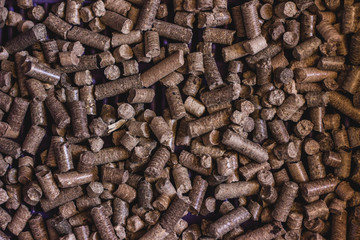 Toilets for Pets, filler wood pine is used in the litter box. A variety of pressed sawdust pellets macro.
