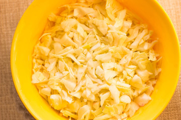 cabbage and cutted cabbage on wooden