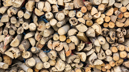 A pile of firewood near a house.