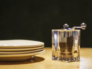 Pepper and white plates on the table