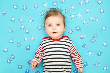 Portrait of adorable 3 months old baby on the blue background, studio shot
