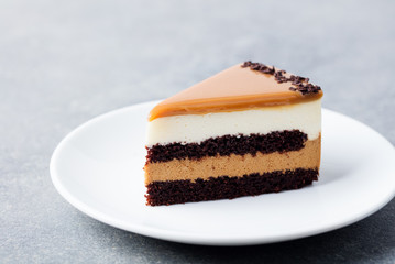 Caramel cake, mousse dessert on a plate. White background.