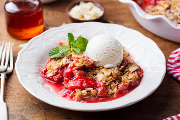 Crumble with berries and fruits with vanilla ice cream.