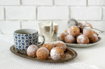 Vanilla krapfen doghnut with coffee. Rustic style.