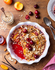 Peach and berry crumble in a baking dish. Top view.