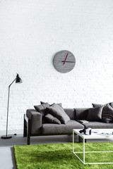 Digital gadgets in cozy interior with modern grey sofa