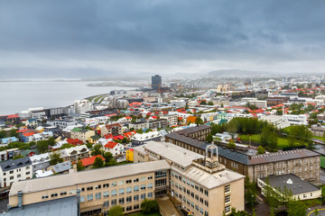 Icelandic capital panorama, streets and colorful resedential buildings with ocean fjord in the background, Reykjavik, Iceland